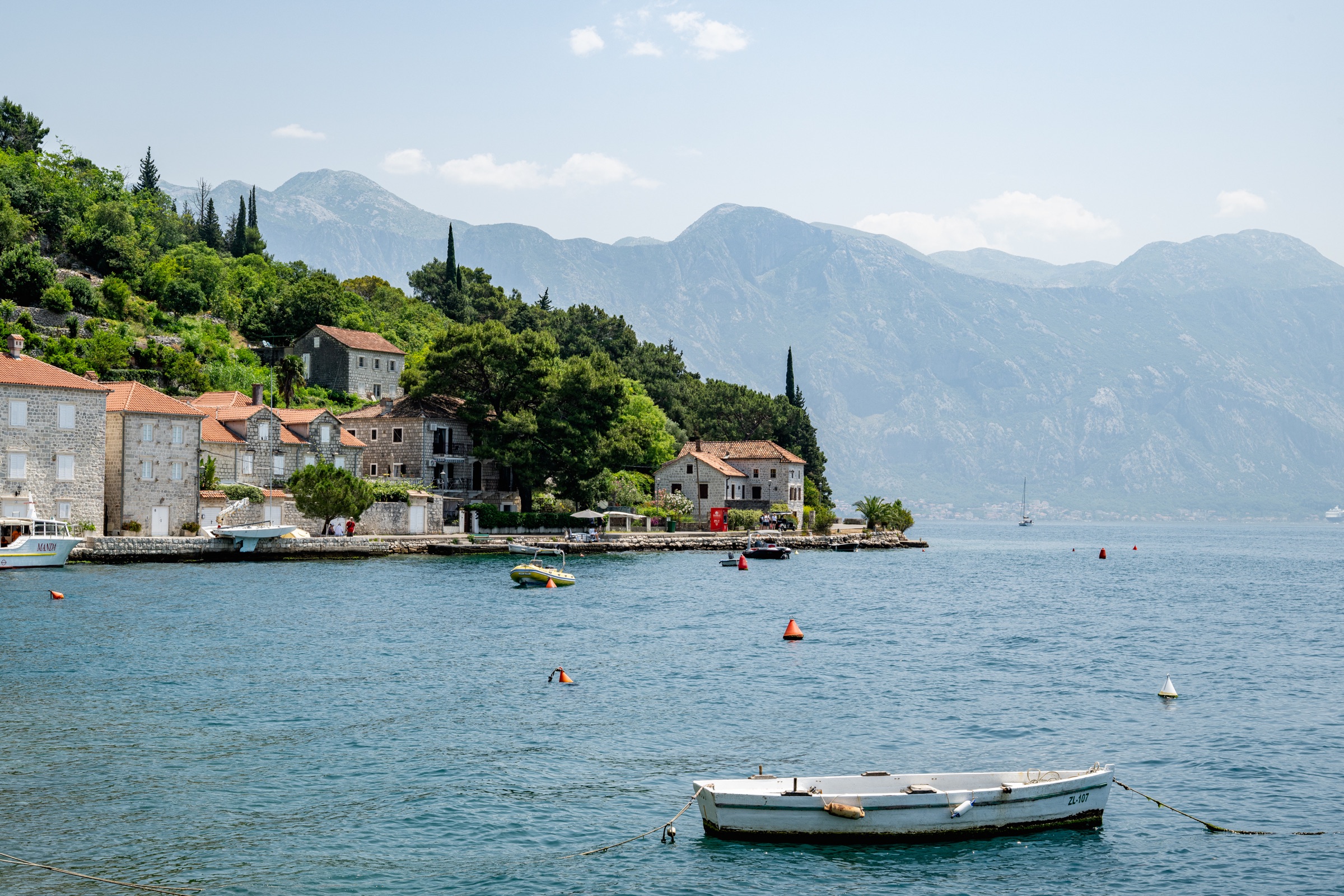 A small village and fishing boat on a calm Adriatic bay