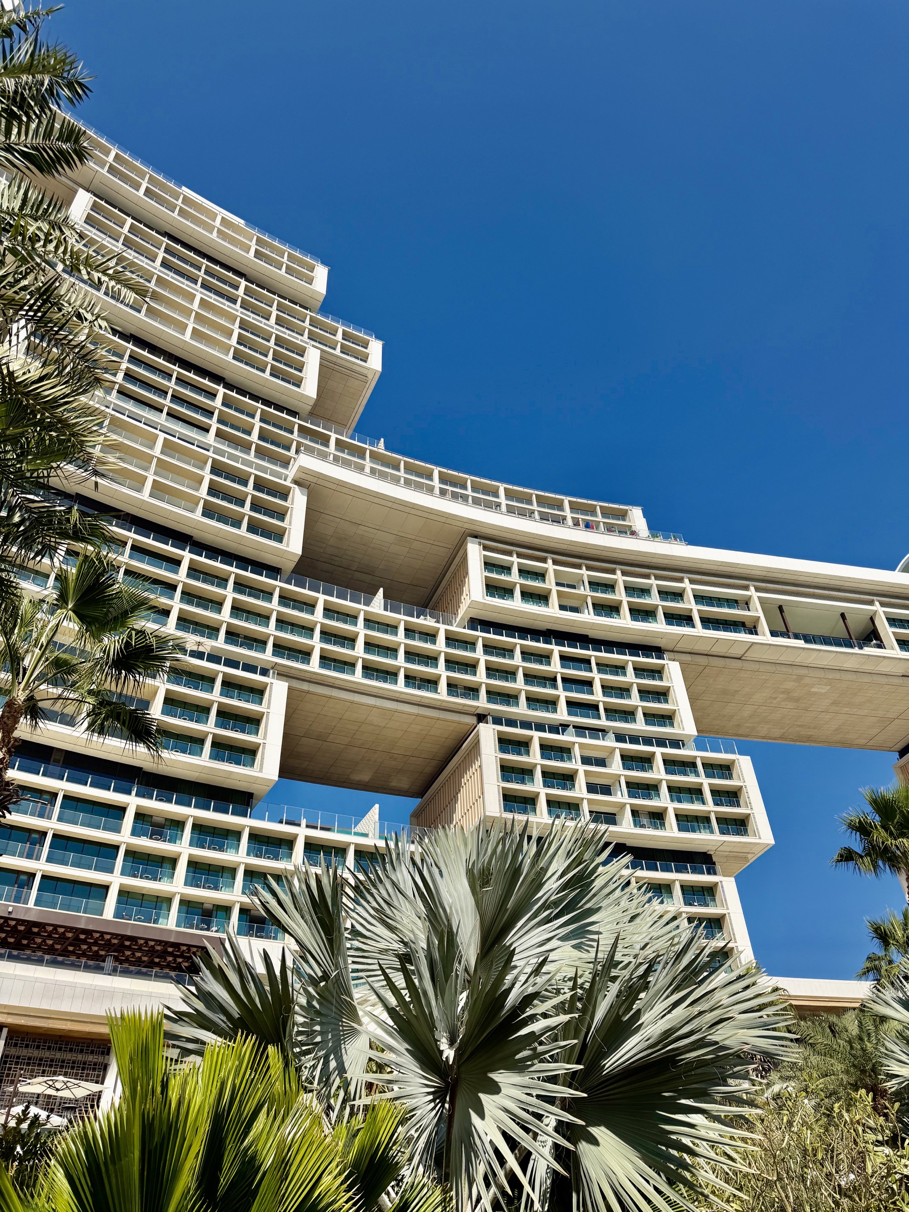 The monumental architecture and palm-lined entrance of Atlantis The Royal in Dubai